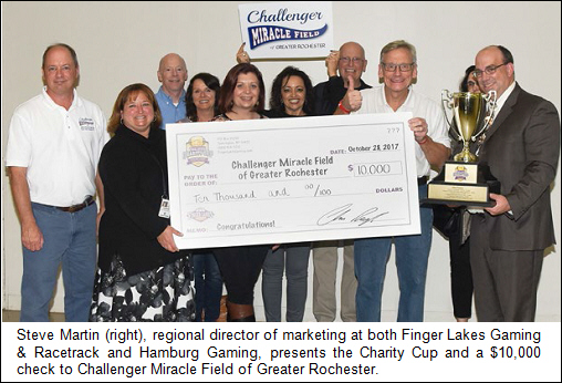 Steve Martin (right), regional director of marketing at both Finger Lakes Gaming & Racetrack and Hamburg Gaming, presents the Charity Cup and a $10,000 check to Challenger Miracle Field of Greater Rochester.