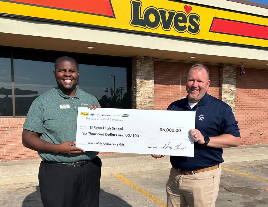 Love's GM, Aaron Gatlin, pictured (on left) with donation check to Tim Pounds, El Reno High School principal.