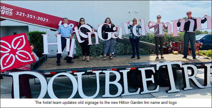 The hotel team updates old signage to the new Hilton Garden Inn name and logo