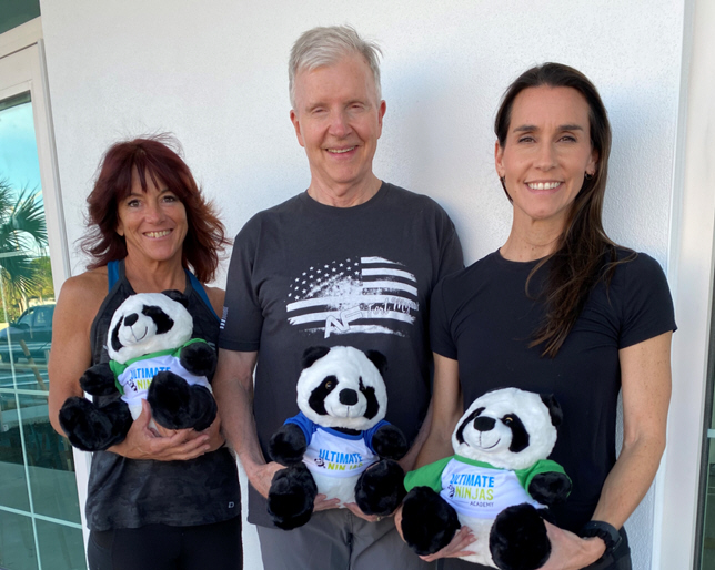 Kristen Gustafson, Ultimate Ninjas Academy Operations Manager, Jim Stewart and Cordula Reichardt, co-owners of Anytime Fitness and the new Ultimate Ninjas Academy with their panda mascots for the youngsters' gym.